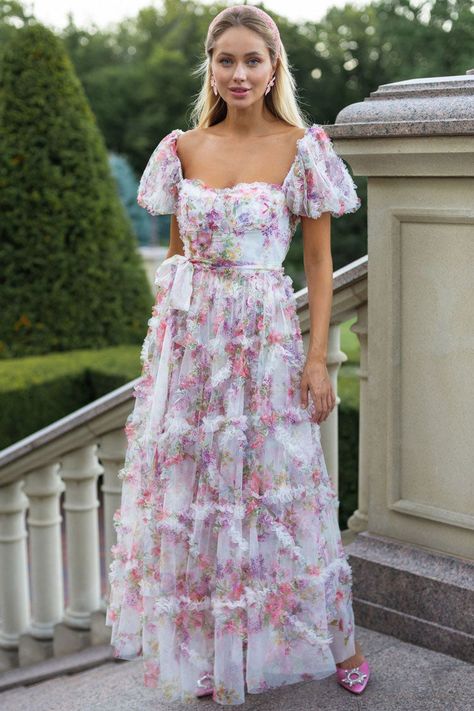 Description: Immerse yourself in a tapestry of blossoms with our blooming floral gown dresses! Crafted from soft tulle, this enchanting printed maxi dress boasts short puff sleeves and a self-tie bow at the waist, creating a breezy ruffle maxi that embodies the vibrant hues of a flourishing garden throughout spring and summer. It's the quintessential outfit for women seeking boutique elegance, perfect for weddings, garden parties, and proms. This fairytale tulle dress, delicately trimmed with st فستان زهري, Floral Gown Dress, Floral Mesh Dress, Prairie Chic, Tie Maxi Dress, Floral Gown, Maxi Gown Dress, Maxi Dress Prom, Maxi Gowns