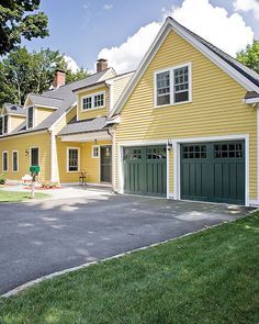 Yellow House Exterior, Carriage Style Garage Doors, Green House Exterior, Custom Garage Doors, Exterior House Colors With Brown Roof, Brown Roof, Carriage Doors, Yellow Cottage, Brown House