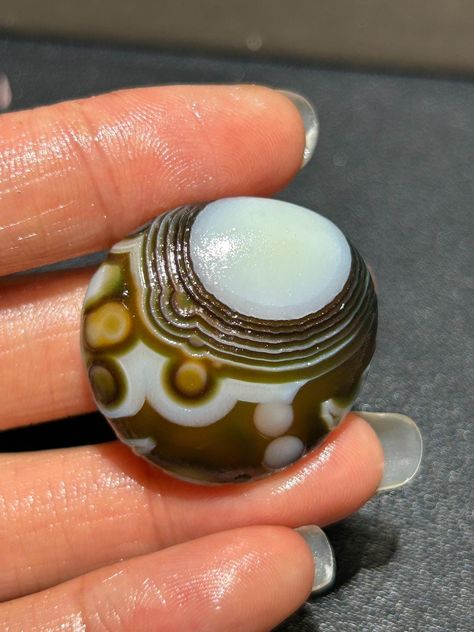 **Gobi Eye Agate Stone from Mongolia Desert, Natural Desert Tumbled Palm Stone, Crystal Healing, Perfect Gift for Energy Balance & Harmony**  Weight: 13 g Size: 30*27*11 mm **Meaning Gobi Eye Agate stone, also known as the "Stone of Protection," is believed to bring balance and harmony to the energy of its surroundings. The name "Gobi Eye Agate" originates from the unique eye-like patterns found in the stone, which are said to resemble the watchful eyes of protective spirits. These stones are fo Eye Agate, Energy Balance, Palm Stone, Stone Crystal, Mongolia, Agate Stone, Crystal Items, Geology, Bead Charms