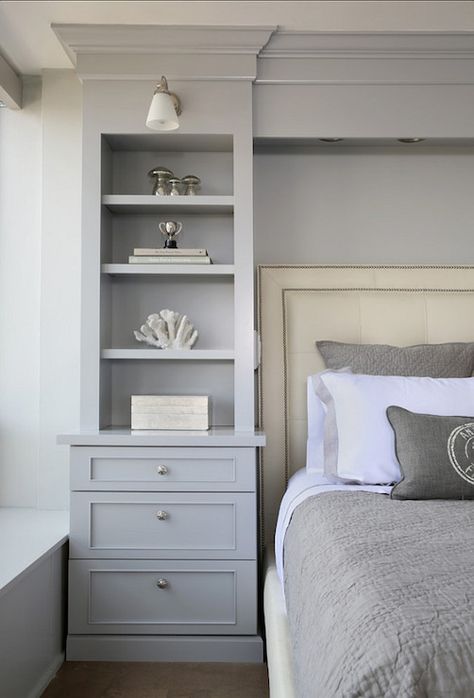 Gorgeous bedroom boasts gray built-in bookcase with lower drawers accented with round brushed nickel pulls lit by a frosted glass wall sconce beside an ivory leather bed with nail-head trim layered with gray bordered bed linens and a gray matelasse coverlet with matching shams. Cabinets Bedroom, Bedroom Built Ins, Transitional Bedroom, Built In Bookcase, Remodel Bedroom, Closet Bedroom, Book Shelf, Beautiful Bedrooms, Dream Bedroom