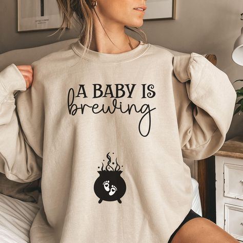 Celebrate your spooky news in style with our Halloween Pregnancy Announcement Sweatshirt! This cozy Halloween Maternity Sweater, featuring a funny "Mom To Be" crewneck design, is the perfect Pregnant Wife Sweater for any Spooky Baby Shower. UNISEX SIZING, relaxed fit. Not a Women's size, please refer to the size chart for more details. HOW TO ORDER: 1. Review all photos. 2. Select size and color from drop down menu.  3. Add to cart, and repeat 1, 2 and 3 for additional items.  PROCESSING AND SHI Halloween Pregnancy Announcement Costume, Wife Sweater, Baby Shower Unisex, Gifts For Pregnant Wife, Halloween Maternity, Halloween Pregnancy Announcement, Cozy Halloween, Pregnant Halloween, Pregnant Wife