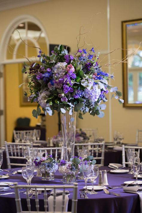 Purple Wedding Reception Table Decor | Silver Chiavari Chairs and Purple and Ivory Tall Table Floral Centerpieces Purple And Silver Wedding Centerpieces, Purple And Blue Centerpieces, Blue Purple And Silver Wedding, Purple And Blue Decorations, Purple Table Settings Wedding, Purple Wedding Reception Tables, Navy Centerpieces, Lavender Wedding Centerpieces, Purple Table Settings