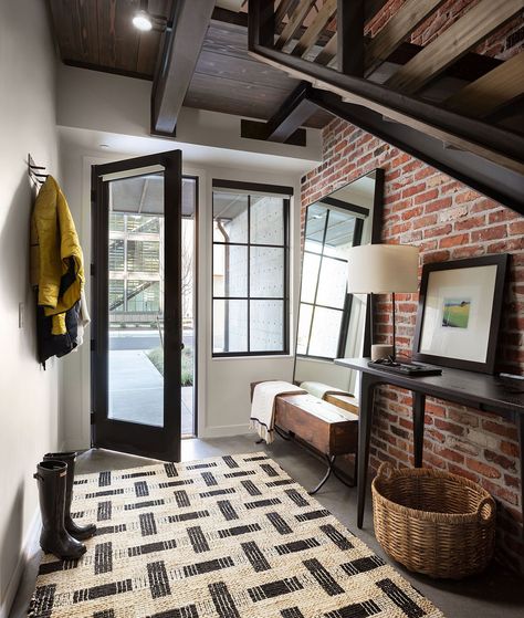 Gorgeous industrial style entryway of stylish Seattle home with an exposed brick wall Industrial Hallway, Coastal Entryway, Painted Brick Walls, Industrial Entryway, Seattle Homes, Grand Hall, Industrial Interior Design, Foyer Design, Entry Way Design