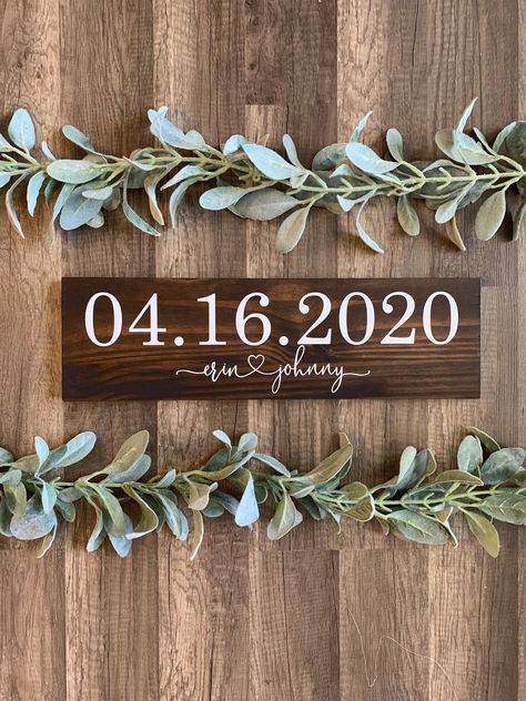 "Our \"save the date\" signs make the perfect prop for your engagement photos! What a fun way to announce your upcoming wedding. After your engagement photos this sign makes a great reception table decoration and then add it to a gallery wall of your wedding photos in your home! This sign measures approximately 5\" x 18\", is stained on both sides, and includes a sawtooth hanger on the back. We use permanent vinyl for the lettering. *If you choose rustic white you will get black lettering*  See Date Decor, Save The Date Illustrations, Wedding Photo Walls, Save The Date Pictures, Engagement Photo Props, Wedding Date Sign, Personalized Wooden Signs, Reception Table Decorations, Announcement Sign