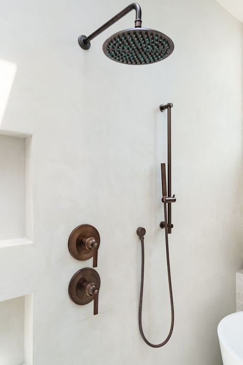 We mixed metals on all the fixtures throughout the bathroom and the shower system is oil-rubbed bronze. We added movement to the walls with Tadelakt, a Moroccan waterproof plaster. It’s a hand-applied wall surfacing technique that gives an imperfect texture and color for an earthy feel. Interior design, bathroom mixed finishes, California bathroom, tadelakt bathroom, bathroom shower systems, renovation bathroom ideas, bathroom renovations, earthy bathroom, before and after renovation. Oil Rubbed Bronze Shower Fixtures, Mixed Metal Bathroom Fixtures, Bronze Shower Fixtures, Oil Rubbed Bronze Bathroom Fixtures, Mixed Metals Bathroom, California Bathroom, Tadelakt Bathroom, Tadelakt Plaster, Waterproof Plaster