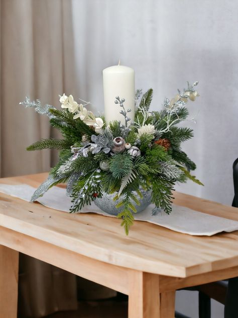 Welcome the most awaited season with this bright and gorgeous Christmas table centrepiece, Christmas table decorations, Christmas table display, Christmas candle display, Festive home decor, Holiday home decor. White and silver centrepiece made up of silver and white  Christmas berries picks adorned and a lot of 3D pine branch of different shade of green and one white tall ( 20cm/7,87 inch tall, 7 cm/ 2.75 inch width)  pillar candles. This arrangement are beautiful and very sparky what you can n Small Xmas Table Decorations, Christmas Wedding Top Table, Modern Christmas Arrangements, Christmas Table Flowers, Home Made Christmas Decor, Centre Table Noel, Silver Christmas Table Decorations, Christmas Coffee Table Decor Living Rooms, Side Table Christmas Decor