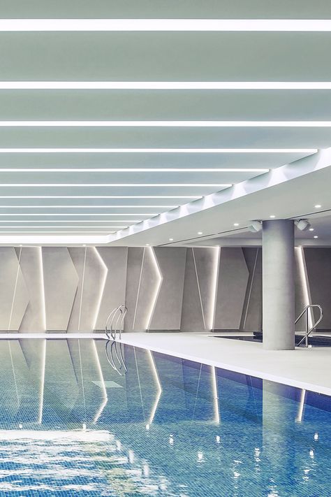 Indoor swimming pool with LED ceiling and wall lighting designs Smooth Aesthetic, Leicester City Football Club, Hydrotherapy Pool, Indoor Swimming Pool Design, Kindergarten Interior, Leicester City Fc, Indoor Swimming Pool, Suspended Ceiling, Tennis Club