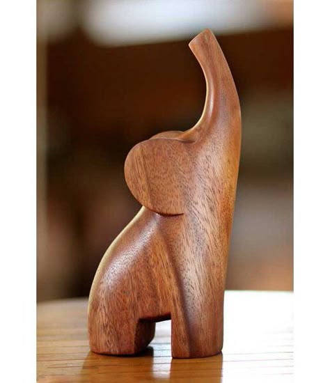 From Made Wirata, this sleek figurine distills the essence of the elephant in a modern figurine. With its trunk raised in a joyous trumpet, the forest creature triumphs over the challenges of its habitat. Art Sculpture En Bois, Baby Elefant, Wooden Elephant, Elephant Sculpture, Wood Carving Designs, Wood Carving Patterns, Elephant Figurines, Into The Wood, Wood Carving Art