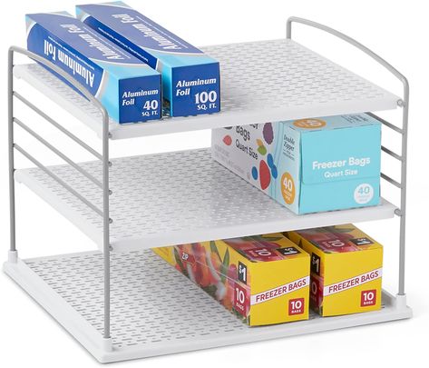 ADJUSTABLE: Shelves adjust in 1” increments to fit standard and oversize kitchen wrap, aluminum foil, parchment/wax paper and food bag boxes. DURABLE: Sturdy steel wires hold up to 20 pounds. Now you can store all your boxes in one spot to maximize vertical storage space and minimize box clutter. MULTIPLE USES: Great for organizing any long boxes like foils, wraps, baggies, pasta, crackers and cookies. It also works well under sink in the bathroom for extra toothpaste. Foil Storage, Kitchen And Pantry, Kitchen Wrap, Slide Box, Pot Lid Organization, Clear Bins, Pantry Organizers, Small Kitchen Organization, Cabinet Boxes