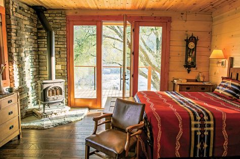 A crisp log home bedroom in Sequoia Country. Wood Burning Stove In Bedroom, Wood Stove Bedroom, Wood Burning Stove Bedroom, Log Home Bedroom, Ranch Bedroom, Western House, Bush House, Log Home Interior, Prairie Farmhouse