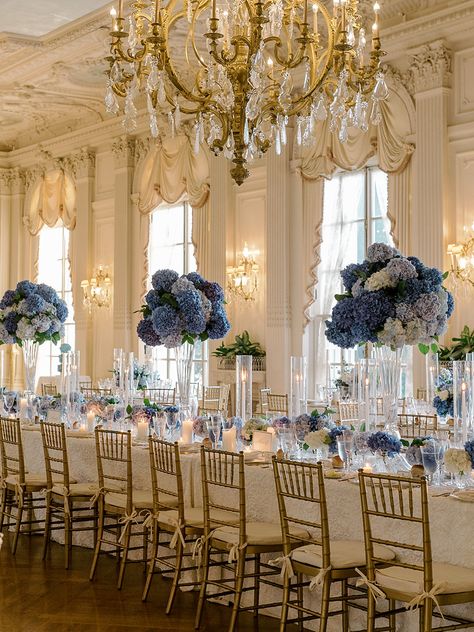 A long candle lit table with blue flowers down the center, setup for dinner Blue Wedding Theme Centerpieces, Tall Flower Centerpieces, Blue Hydrangea Centerpieces, Hydrangea Centerpiece Wedding, Royal Blue Wedding Theme, French Blue Wedding, Newport Mansions, Fairytale Wedding Theme, Blue Hydrangea Wedding