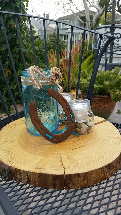 Wedding shower centerpieces. Blue mason jar, horseshoe with teal ribbon, votive inserted into small mason jars all on a tree cookie. Teal Wedding Centerpiece Ideas, Country Teal Wedding, Turquoise Rustic Wedding, Teal Wedding Centerpieces, Burlap Wedding Centerpieces, Teal Party Decorations, Bridal Shower Themes Rustic, Dark Teal Weddings, Boot Centerpiece