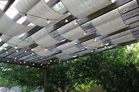 Doctor up a boring pergola by weaving wide strips of drop cloth and string lights through slats for a dreamy outdoor canopy effect. Shaded Pergola, Cloth Pergola, Ombra Pergola, Ideas Terraza, Patio Pictures, Pergola Diy, Backyard Shade, Summer Diy Projects, Pergola Swing