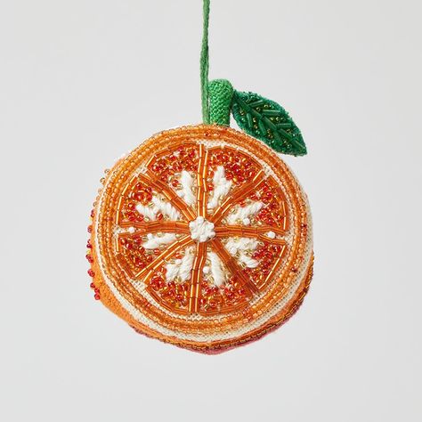 "Share the zest and joy of life with this bright and succulently beaded orange ornament. With its fresh citrus shine and its delicate array of beads and colors, this is a perfect hostess gift for all seasons. It has a linen backing with additional beaded details on the back. Looks beautiful as a charm for your festive harvest table. * All details and stitching are hand-embroidered. * Our ornaments come ready to hang with a string attached. * Hand-beaded linen * Fairly traded and made with love b Beaded Orange, Fall Linen, Orange Ornaments, Fruit Ornaments, Beaded Shirt, Perfect Hostess, Tambour Embroidery, Wrapping Gift Cards, Bead Board