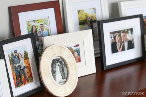 It's time to stop hiding memories behind other memories Display Family Photos, Diy Playbook, Photo Wall Gallery, Picture Ledge, Picture Frame Display, Table Display, Decorating With Pictures, Mantel Decorations, Small Frame