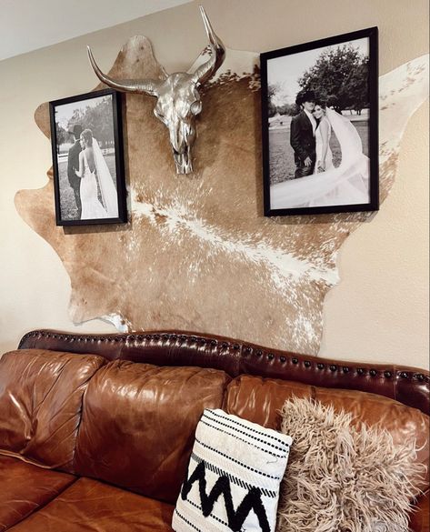 Hang Cowhide Rug On Wall, Elk Hide Decor Ideas, Cowhide Behind Bed On Wall, Ranch Style Office Decor, Cow Hyde On Wall, Deer Skull Gallery Wall, Boho Picture Collage Wall, Cowhide Hung On Wall, Cowhide In Bedroom