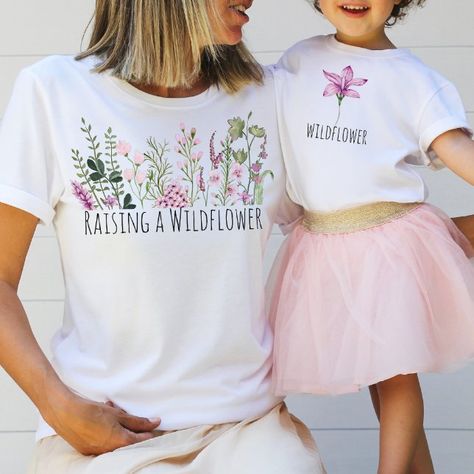 Customizable Mom and Daughter Tshirts. Note: Affiliate link Mom And Daughter Matching Shirts, Green Wildflowers, Mini Outfits, 2023 Wishlist, Future Generation, Mini Outfit, Mom And Daughter Matching, Purple Wildflowers, New Mama