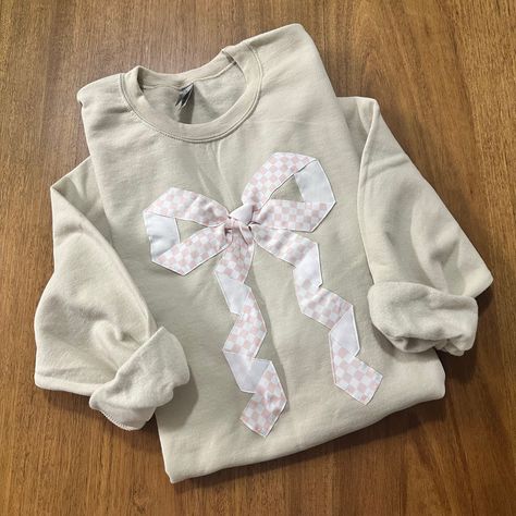 This cute design makes the perfect gift for the bow lover in you life. The beautiful checkered ribbon is sewn on. Go up in size for a more oversized look. All sales are final due to customization of product. Will ship USPS or UPS unless requested otherwise. Colors and exact shape of bow may differ slightly from appearance on screen. Bow Sweatshirt Diy, Ribbon Sweater, Thrift Flip Ideas, Bow Sweatshirt, Trendy Bows, Patchwork Sweatshirt, Quilted Sweatshirt, Cute Ribbon, Scrap Fabric Crafts