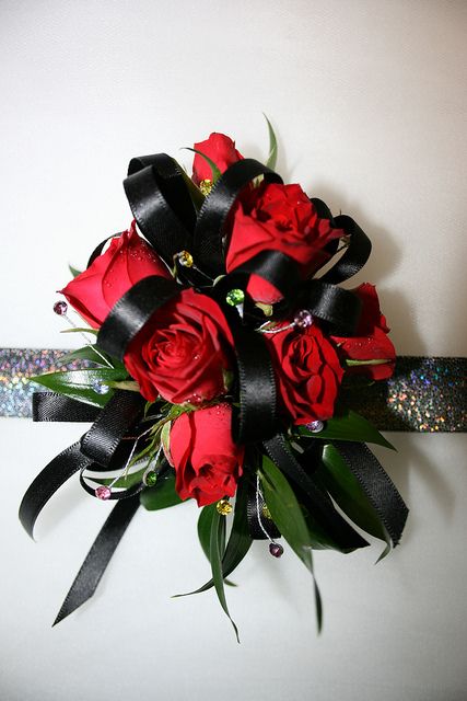 Corsage Red And Black, Red Spray Rose, Red Corsages, Rose Wrist Corsage, Orchid Corsages, Homecoming Flowers, Prom Corsage And Boutonniere, Hoco Ideas, Rose Corsage