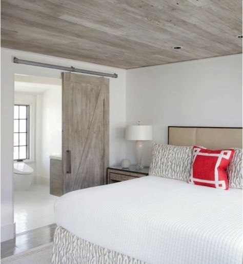 A modern version of the look is seen in this Florida bedroom. Keeping the ceiling, barn door, and bathroom vanity the same material creates flow and serenity, while the rustic wood itself is a cool feature. Florida Bedroom, House Ceiling Design, Basement Apartment, Basement Ceiling, Basement Bedrooms, Coastal Bedrooms, Coastal Bedroom, Wood Ceilings, Floor To Ceiling Windows