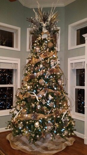 30 Gorgeous Christmas Tree Decorating Ideas You Should Try This Year Deer Tree Christmas, Christmas Tree With Deer Antlers, Deer Christmas Tree Topper, Christmas Trees With Burlap Ribbon, Deer Antler Christmas Tree Topper, Antler Tree Christmas, Antler Christmas Tree Topper, Christmas Tree With Star On Top, Deer Tree Topper