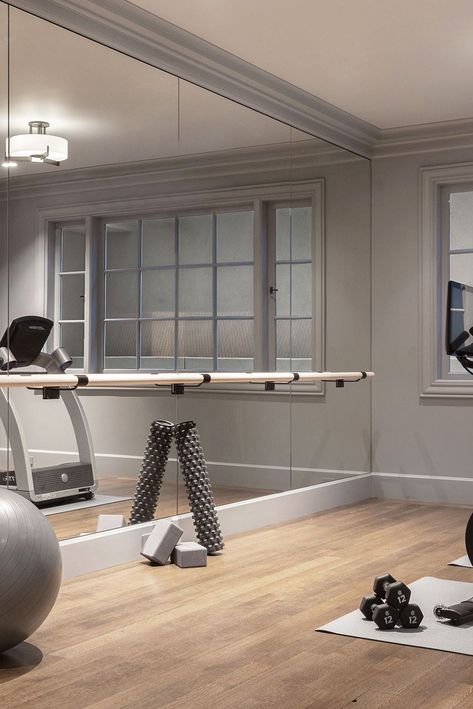 modern gray home gym Full Wall Mirror Gym, Home Gym Stair Master, Exercise Room Mirrors, Home Gym In Basement Ideas, House Gym Room Small Spaces, Exercise Room Design, Basement Exercise Room Ideas, Chic Home Gym, Basement Must Haves