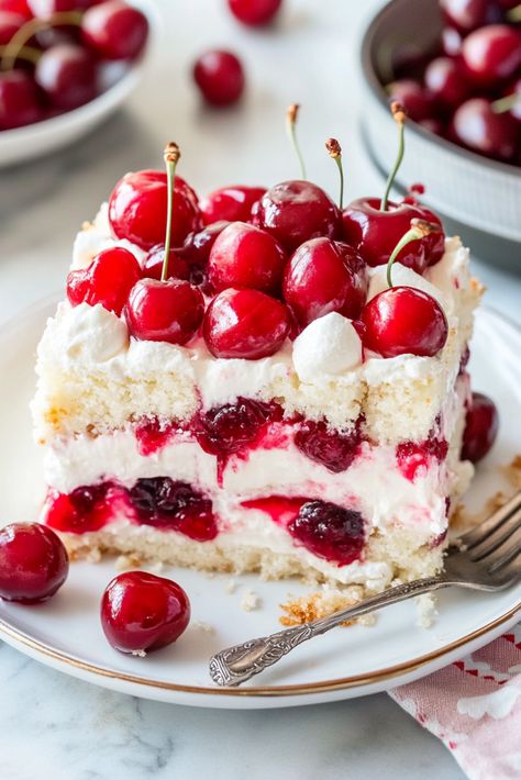 Heaven on Earth Cake is a delightfully simple layered dessert crafted with ready-made ingredients. It features layers of fluffy angel food cake, sweet cherry pie filling, smooth vanilla pudding, and airy whipped topping, all finished with a sprinkle of sliced almonds. Utilizing canned cherry pie filling offers a tasty shortcut for this dessert. Explore other Angel Food Cake Layer Cake, Cheapest Desserts To Make, Cherry Pie Filling Desserts, Lush Dessert Recipes, Heaven On Earth Cake Recipe, Canned Cherry Pie Filling, Vanilla Pudding Desserts, Angel Food Cake Trifle, Cherry Almond Cake