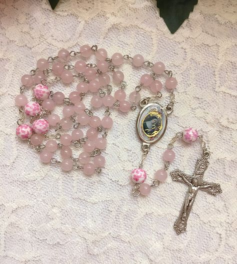 Handmade St. Rita of Cascia rosary beads made with 6mm pink Rose Quartz beads and 8mm ceramic pink & white floral beads. The center and crucifix are both made in Italy. Pink Rosary Aesthetic, Rosary Aesthetic, Rita Of Cascia, Pink Rosary, Flower Rosary, Saint Rita, St Rita Of Cascia, Pink Core, Pink Items