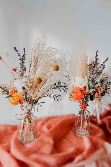 Our gorgeous bouquets and centerpieces for tables will make your special event even more beautiful and memorable! Centerpieces are very important pieces of decoration because they draw attention to the tables and bring event decor together. Impress your guests and add more life to the event venue with our beautiful dried flowers bouquets! Jars With Flowers Centerpieces, Boho Spring Bouquet, Orange Ranunculus Centerpiece, Rustic Modern Wedding Centerpieces, Wedding Centerpieces Dried Flowers, Dried Flower Tablescape, Dried Flower Wedding Decor Centerpieces, Dried Floral Wedding Decor, Dried Wildflower Centerpieces