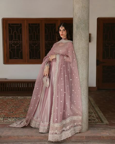 Faiza Saqlain on Instagram: "Mehermah - Luxe Formals '24  Evoking vintage glamour, Halina reimagines the classic pishwas in a vivid seashell pink hue. Crafted from luxe tissue, the pishwas is rendered with intricate kora and dabka motifs. Paired with a sheer, embroidered organza dupatta and silk churidaar, this piece, with its perfect draping, is a true symphony of style.   #FaizaSaqlain #Mehermah #Luxuryfestive #Formals #Launchingsoon" Pink Desi Clothes, Desi Shaadi Outfits, Baat Pakki Outfit, Pakistani Gown, New Pakistani Dresses, Faiza Saqlain, Wedding Outfits Indian, Sheer Dupatta, Seashell Pink