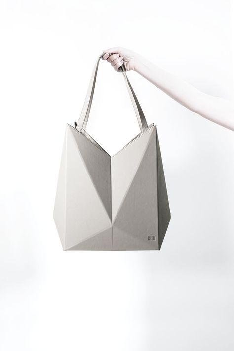 LIFESTYLE BRAND FINELL LAUNCHES DEBUT HANDBAG COLLECTION Geometric Bag Design, 3d Bag Design, Origami Product Design, Geometric Product Design, Futuristic Handbag, Origami Product, Origami Handbag, Origami Products, Geometric Products