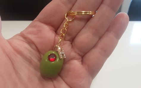 Personalized Handmade Martini Olive Keychains. Choose your size of Olive and whether you would like a red clay or faux gemstone center. Enter initial choice in Personalization Box. These olives are handcrafted by yours truly💝  Large size olive with fake gemstone is pictured on keychain. Once I have attached initial, it can't be removed. Message me with any special requests. Are you looking for the assortment of olives? They Are Here:  https://www.etsy.com/ca/listing/1337501454/handmade-miniature-olivesgreen-olives?click_key=f39b3a178403a6c33356d70306af87fa3054373d%3A1337501454&click_sum=46bcaca6&ref=shop_home_active_1&crt=1&sts=1 As they are handmade, each olive may differ from the next. (Color may differ from monitor to monitor and from each batch of color I mix ) Shipping Within Canada Unique Key Chain, Trendy Gifts For Women, Fun Keychains, Gifts For Mother In Law, Cool Keychain, Keychain Collection, Martini Olive, Martini Olives, Men's Gifts