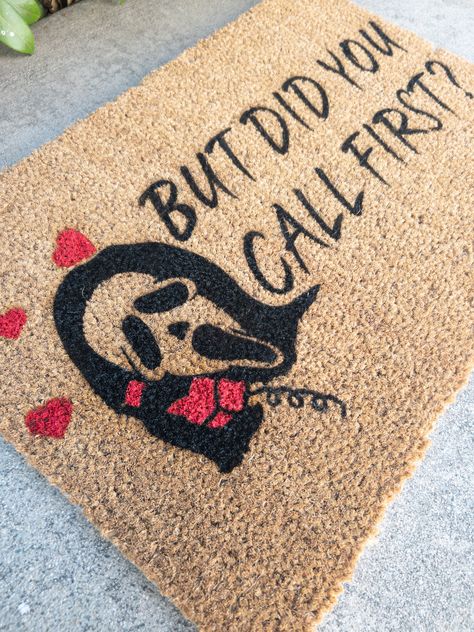 Ghostface Doormat | Scream Halloween Doormat Our mats are made of 100% natural coir material with PVC slip resistant rubber backing. Natural surface provides durability and traction to wipe your shoes. Suitable for indoor and outdoor use. All of our designs are hand-painted made with love just for you. But Did You Call First Door Mat, Witchy Welcome Mat, Halloween Outdoor Mat Diy, Spooky Door Mat Ideas, Diy Halloween Floor Mat, Halloween Mat Painting Ideas, Cricut Halloween Door Mat, Cricut Halloween Decorations Outdoor, Fall Rug Ideas