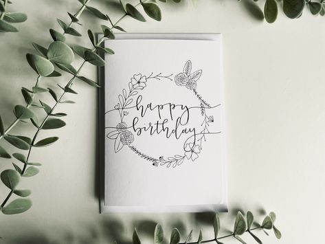 "Floral Circle Happy Birthday Card Wish your loved ones Happy Birthday with this elegant floral calligraphy card!  C6 white card with a white envelope. All of our packaging is plastic free and can be recycled.  Outside: \"Happy Birthday\" in black calligraphy surrounded by a floral circle Inside: Blank  If you would like us to write a personalised message inside of your cards to send directly to your recipients, just write your message into the 'personalisation' section of your order. We are cur Happy Birthday In Black, Floral Calligraphy, Black Calligraphy, Floral Circle, Calligraphy Cards, Hand Of Cards, Handmade Greetings, Happy Birthday Card, Elegant Floral