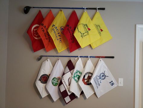 My husband wanted to display his golf flags collection and I came up with this idea to use some clubs he played with in college and tie his flags to it. We love how it turned out! Easy to make. Golf Themed Powder Room, Golf Flag Display Ideas, Golf Flag Display, Golf Decorating Ideas, Flag Display Ideas, Golf Bedroom, Golf Flags, Office Golf, Diy Golf