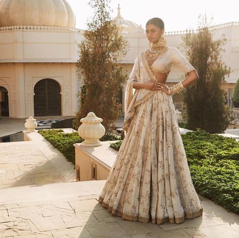 Not all brides are fans of classic red or pink lehenga. Ivory Lehenga is a perfect example of chicness and simplicity at your intimate wedding.  #sabyasachilehenga #sabyasachibride #indianwedding #whitelehenga #simplelehenga #offwhitelehenga #shaadisaga #intimatewedding Sabyasachi Bridesmaid, Sabyasachi Lehenga Bridal, भारतीय दुल्हन संबंधी, Sabyasachi Bridal, Gold Lehenga, Simple Lehenga, Sabyasachi Lehenga, Nikkah Dress, Indian Outfits Lehenga