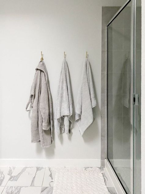 How to hang towel hooks in your bathroom to replace your towel bar - it's a quick and simple project that will make a huge difference! Towel Hook Height Bathroom, Where To Hang Robe Hooks In Bathroom, Modern Bathroom Towel Hooks, Hooks On Bathroom Wall, How High To Hang Towel Hooks, Towel Hook Height, Towel Hook Placement Bathroom, Where To Hang Towel Hooks In Bathroom, Towels Hanging In Bathroom