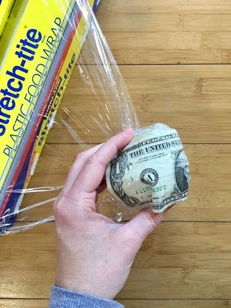 Money Ball Challenge Game, How To Make A Saran Wrap Ball, Plastic Wrap Christmas Game, Money Ball Game, Gifts For Saran Wrap Ball Game, Christmas Unwrapping Gift Game, Lottery Ticket Game Ideas Fun, Cellophane Ball Game Christmas, Christmas Games For Family Activities