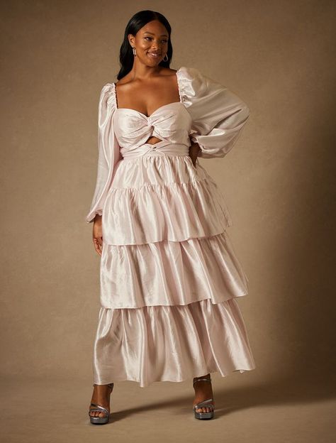 This Bridal by ELOQUII Tiered Dress - Blush is one of our Women's Plus Size Dresses from ELOQUII.  Bridal by ELOQUII Tiered DressLong puff sleeveTwisted details at front bust and waistTiered skirtCenter back zipperNon-stretch shell and liningFitted bodiceLength 60" on body (Size 18)Bodice side seams have 1" seam allowance to allow for alterationsBridal styles offer the same fit you know and love from ELOQUII: we recommend ordering the same size you would in other ELOQUII styles. See our Size Cha Plus Size Anniversary Dress, Tea Party Plus Size Outfit, Plus Bridal Dresses, Plus Size Wedding Guest Dresses With Sleeves, Plus Size Drop Waist Dress, White Engagement Dress Plus Size, Plus Size Tiered Dress, Plus Size Tea Party Outfit, Eloquii Bridal