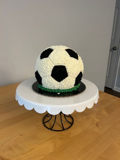 This is an all buttercream soccer ball smash cake for a 1st birthday party. I used the Wilton 6” Ball pan, but needed to create my own template to get the hexagons and pentagons the right size. Turned out super cute! Buttercream Soccer Cake, Soccer Smash Cake, Soccer Theme First Birthday, Soccer 1st Birthday Baby Boy, Soccer First Birthday Party, Ball Cakes For Boys, Soccer Cakes For Boys, Soccer Party Cake, Soccer Cake Ideas For Boys