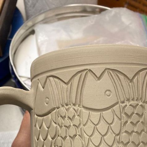 Pamela Johnson-Howe on Instagram: "Still working on a custom order for 12 gargantuan mugs, 6 tessellating fish, 6 sgraffito walleye, northern pike, and musky. The photos don’t show just how big they are. Hopefully bisque firing these and more tomorrow. #herefishyfishy #fish#fishtessellations #mugshot#bigmugs#pottery#carvedclay#potterslife#pottersofinstagram #wisconsinartist#chicagoartist #handmade#upnorth#northwoods#northwoodsart #oneofakind#oneatatime#lakelife #vilascounty #functionalpottery #f Sgraffito Fish Designs, Mug Carving Ideas, Sgraffito Mug, Sgraffito Fish, Fun Objects, Carved Mug, Fish Mug, Northern Pike, Functional Pottery