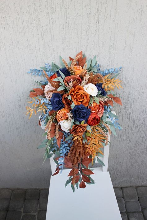 Embrace the beauty of Black Friday sale with rust navy wedding bouquet, a cascading masterpiece designed to adorn your fall wedding. With an enchanting blend of rust and navy, this bouquet captures the essence of the season, making it a perfect choice for your bridal needs. Dive into the elegance of bridal Black Friday to elevate your special day with this captivating bouquet that harmonizes the richness of autumn with timeless beauty. ○ Color: dusty blue, orange, beige, green ○ Personalization: I can make changes to your wishes ○ Processing time: 1 - 2 weeks ○ Shipping time: 7 - 14 business days NOTE  ○ I ship with REGISTERED mail and you will get a tracking number.  ○ All items will be carefully packed in special package materials.  ○ The actual color may differ slightly from the one you Fall Color Palette With Navy, Navy Blue And Rust Wedding Bouquet, Royal Blue And Rust Wedding, Blue And Copper Wedding Flowers, Fall Beach Wedding Flowers, Rust And Beige Wedding, Fall Wedding Blue And Green, Rust And Blue Wedding, Rust Navy Wedding