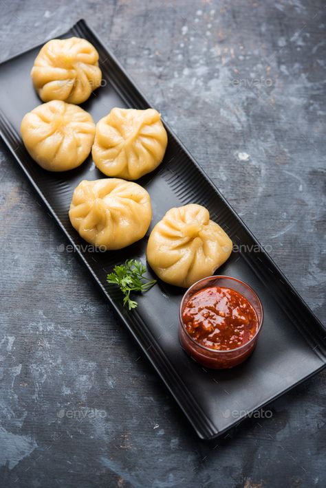 Momos by stockimagefactory. Traditional dumpling momos food from Nepal served with tomato chutney over moody background #Sponsored #dumpling, #momos, #food, #Momos Veg Momos Photography, Momos Wallpaper Food, Momo Plating, Momos Menu Design, Momos Plating Ideas, Momo Food Photography, Momos Food Photography, Momos Picture, Food Photography At Home