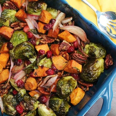 Maple Roasted Brussels Sprouts and Sweet Potatoes with Cranberries and Pecans - Brussels sprout and sweet potatoes are roasted together with cranberries, pecans, and a maple balsamic glaze, getting crispy and carmelized.  This makes for a wonderful Thanksgiving side dish or for other holidays and celebrations throughout the fall and winter! #thanksgivingsidedishes #thanksgivingrecipes #vegetariansidedishes #vegansidedishes #roastedveggies Brussel Sprouts And Sweet Potato Recipe, Brussels Sprouts And Sweet Potatoes, Sprouting Sweet Potatoes, Maple Balsamic, Thanksgiving Side Dish, Comidas Fitness, Roasted Brussel, Roasted Brussels Sprouts, Sprout Recipes