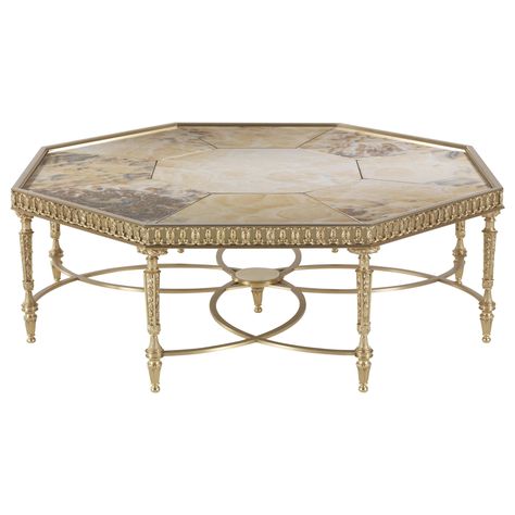 An elaborate brass structure with eight skillfully chiseled legs and a play of curving lines that intersect creating a flower-shaped element with a central element in Cloudy onyx. That’s the artistic base that holds the octagonal top in precious grey onyx. A Louis XVI-style piece of furniture creatively revisited in a brighter, contemporary version. Lumière central table with structure in lost-wax cast brass with gold finishing. Top in Cloudy Onyx. French Modern Coffee Table, Contemporary Living Room Coffee Tables, Cofee Tables, Central Table, Long Sofa Table, Center Table Living Room, Caracole Furniture, French Style Interior, Luxury Coffee