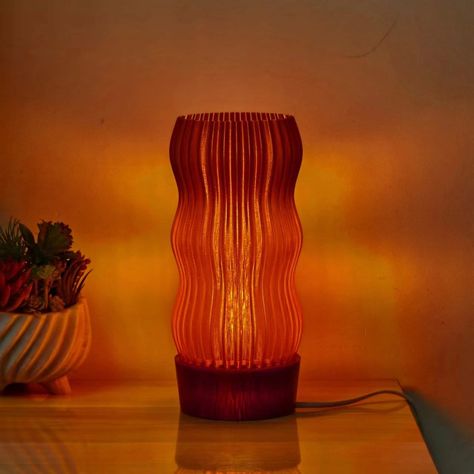 Looking for a unique and eco-friendly lighting solution for your home? Look no further than our Wave Table Lamp! Crafted from locally sourced and recycled plastic, this lamp is both sustainable and stylish. Its captivating wavy design is inspired by Art Deco aesthetics, adding a touch of retro charm to any space. Measuring at 255x115x115mm (12.6x4.7x4.7in) and with a cable length of 1 meter (3.3 Feet), the Wave Lamp is suitable for use with LED bulbs only, with our advised bulb being a 12W A15 L Warm Lamps Bedroom, Warm Table Lamp, Warm Lights Living Room, Cozy Bedroom Lamp, Cozy Table Lamp, Bedside Lamp Aesthetic, Ambient Bedroom Lighting, Cool Lamps Bedrooms, Lamparas Aesthetic