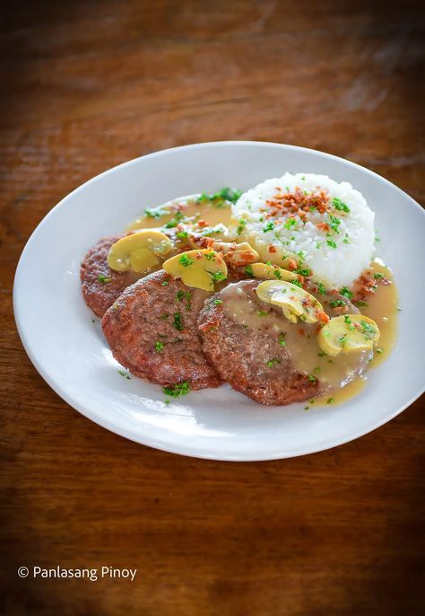 If, like me, and most other Filipinos, you enjoy eating tender, juicy meat with a strong umami flavor, you will surely enjoy this recipe. I love this Pinoy Burger Steak dish as it really simplifies the process of cooking up a great patty dish. How? It makes use of just a few essential ingredients to... Read On → The post Pinoy Buger Steak With Gravy appeared first on Panlasang Pinoy. Steak Gravy Recipe, Steak Gravy, Steak With Gravy, Burger Steak, Pork Chops And Gravy, Panlasang Pinoy, Steak Dishes, Steak And Mushrooms, Beef And Rice