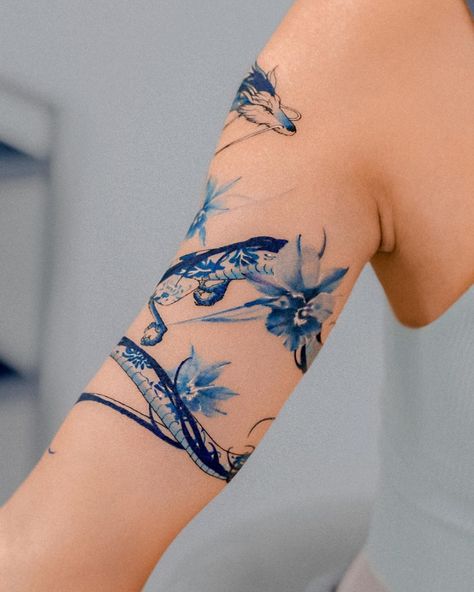 Porcelain haku and blue irises wrapped around the arm 🐉💙 Thank you :) @e.nal.tattoo @vismstudio | Instagram Blue Flower Shoulder Tattoo, Blue Arm Tattoos For Women, Blue Haku Tattoo, Blue And Orange Tattoo, Blue Shoulder Tattoo, Haiku Dragon Tattoo, Light Blue Ink Tattoo, Porcelain Blue Tattoo, Haku Arm Tattoo