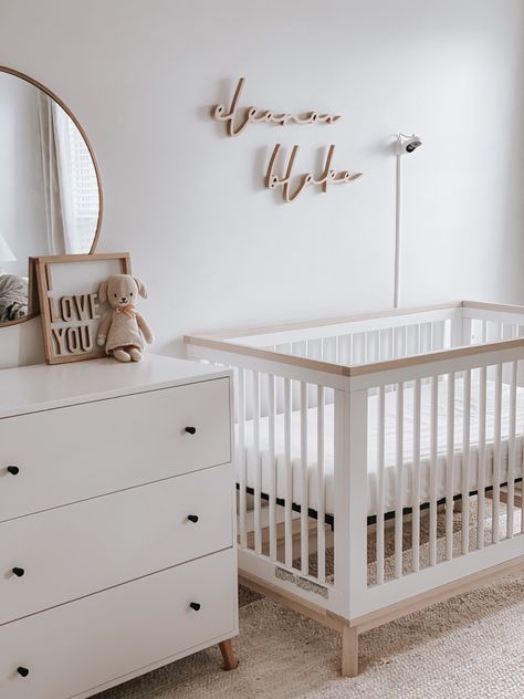 Girl neutral nursery. White dresser. Target mirror. Owlet monitor. Wooden name sign. Cuddle and kind. White And Wooden Nursery, Neutral Nursery Name Sign, White Crib And Dresser Nursery, Grey White And Natural Wood Nursery, Wooden Name Nursery, White Wood Nursery, Baby Nursery White Furniture, Minimalist Disney Nursery, Nursery Mood Board Neutral