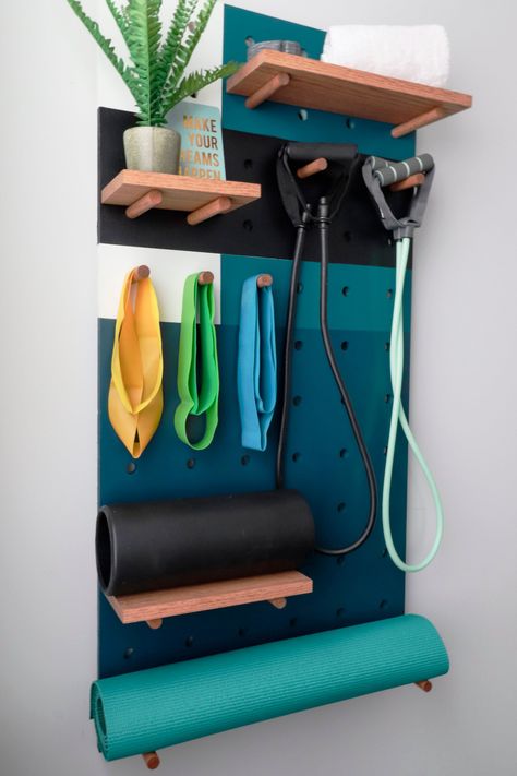 Keep your home exercise equipment accessible—and out of the way—with these space-efficient storage solutions. Organize Workout Equipment, Workout Gear Storage, Exercise Ball Storage, Fancy Garage, Basement Update, Fitness Storage, Yoga Storage, Home Exercise Equipment, Gym Storage